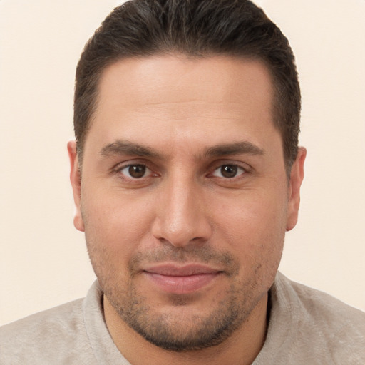 Joyful white young-adult male with short  brown hair and brown eyes