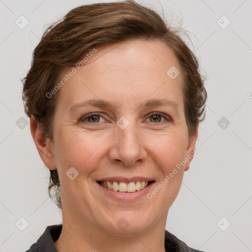 Joyful white adult female with short  brown hair and grey eyes