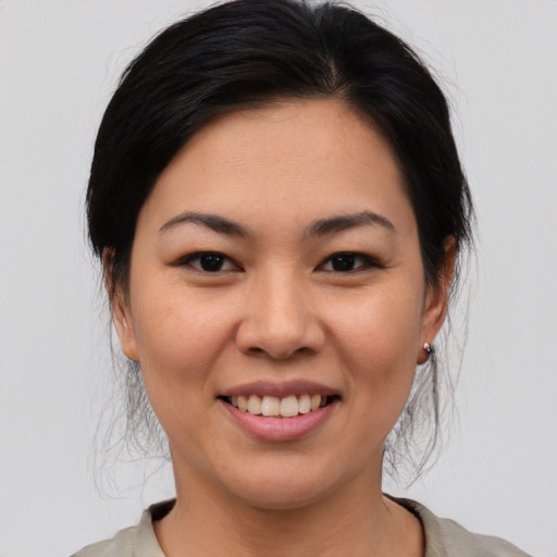 Joyful asian young-adult female with medium  brown hair and brown eyes