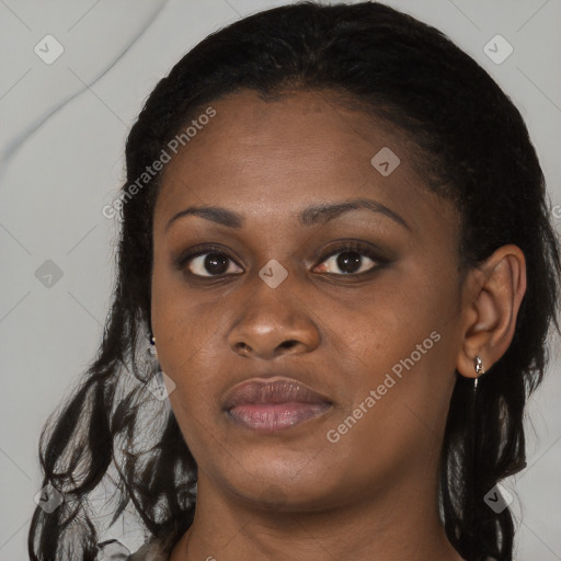 Joyful black young-adult female with long  black hair and brown eyes