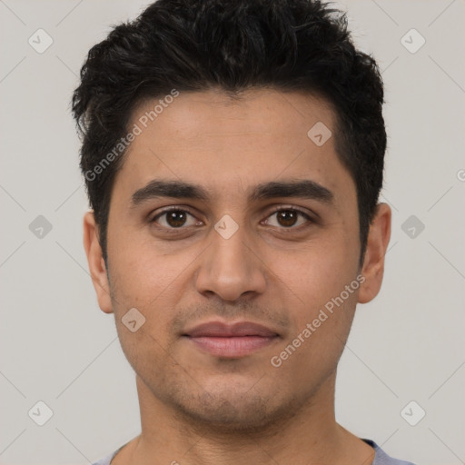 Joyful white young-adult male with short  black hair and brown eyes