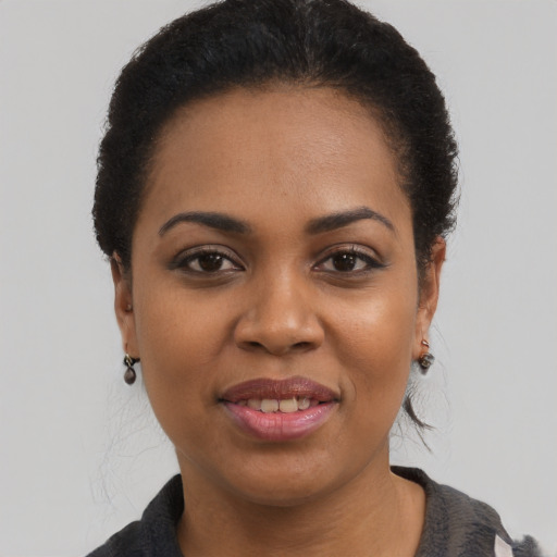 Joyful latino young-adult female with short  black hair and brown eyes