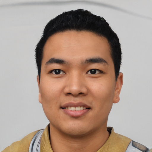 Joyful asian young-adult male with short  black hair and brown eyes