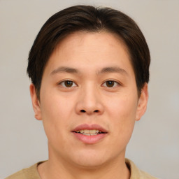 Joyful asian young-adult male with short  brown hair and brown eyes