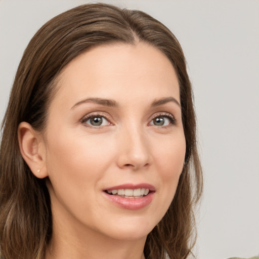 Joyful white young-adult female with long  brown hair and grey eyes