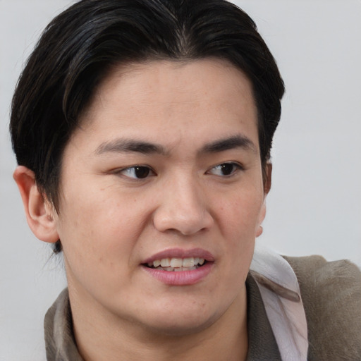 Joyful asian young-adult male with short  brown hair and brown eyes