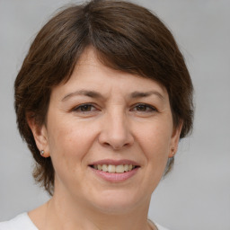 Joyful white adult female with medium  brown hair and brown eyes