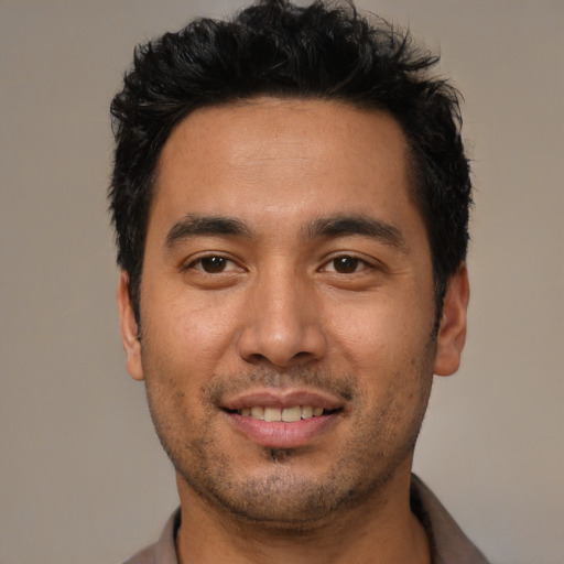 Joyful white young-adult male with short  black hair and brown eyes