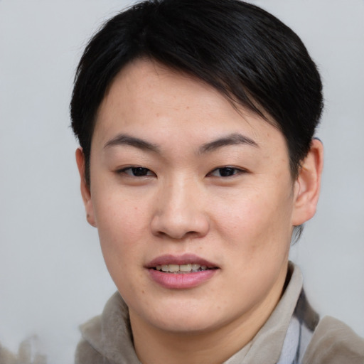 Joyful asian young-adult female with short  brown hair and brown eyes