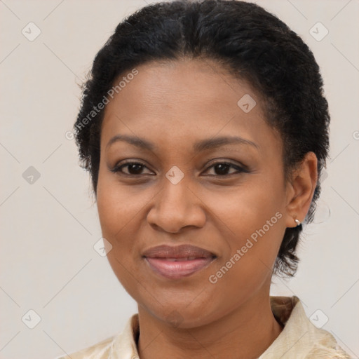 Joyful black adult female with short  brown hair and brown eyes