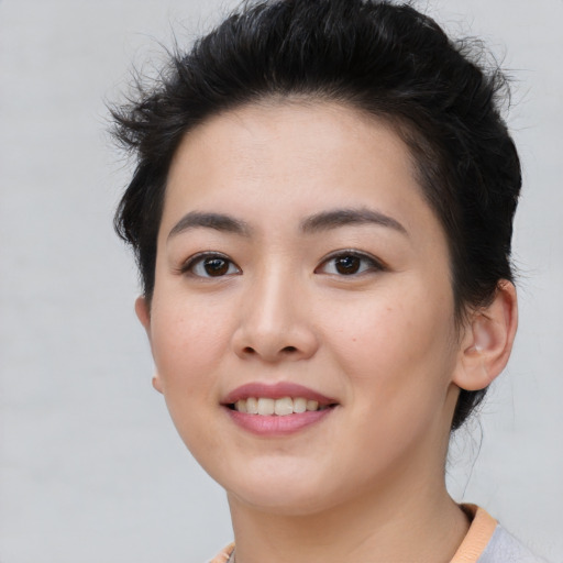 Joyful asian young-adult female with short  brown hair and brown eyes