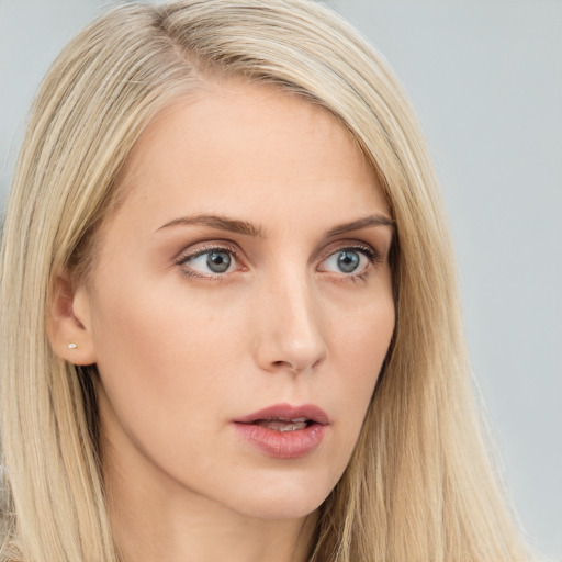 Neutral white young-adult female with long  brown hair and blue eyes