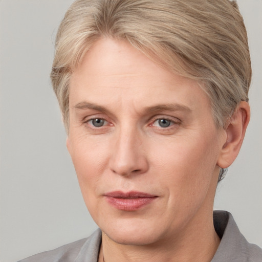 Joyful white adult female with short  brown hair and grey eyes