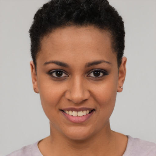 Joyful latino young-adult female with short  black hair and brown eyes