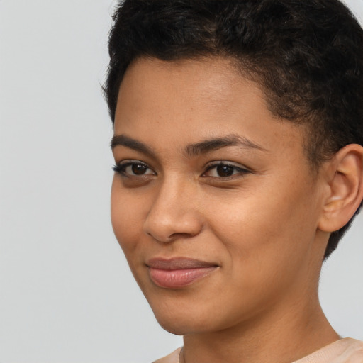 Joyful latino young-adult female with short  brown hair and brown eyes