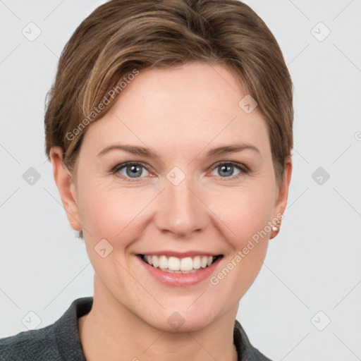 Joyful white young-adult female with short  brown hair and grey eyes