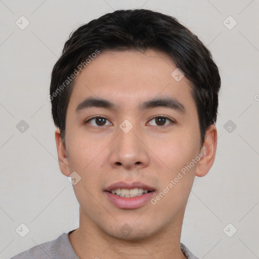 Joyful asian young-adult male with short  black hair and brown eyes