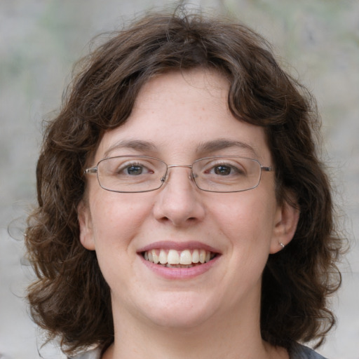 Joyful white young-adult female with medium  brown hair and green eyes