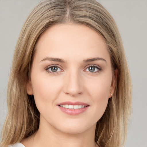 Joyful white young-adult female with medium  brown hair and green eyes