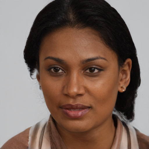 Joyful black young-adult female with medium  brown hair and brown eyes