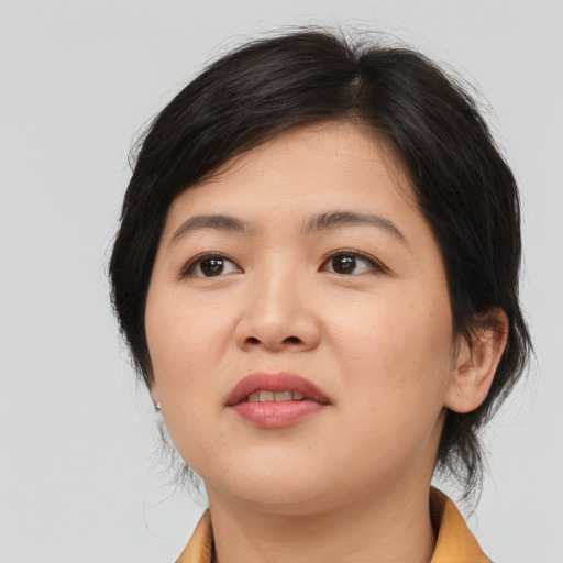 Joyful asian young-adult female with medium  brown hair and brown eyes