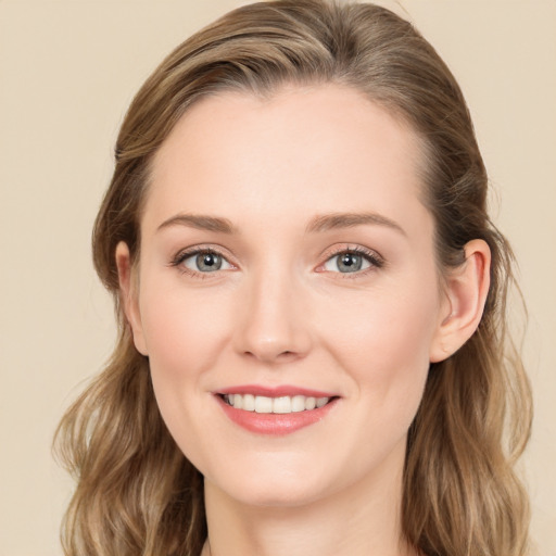 Joyful white young-adult female with long  brown hair and grey eyes