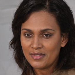 Joyful white adult female with long  brown hair and brown eyes