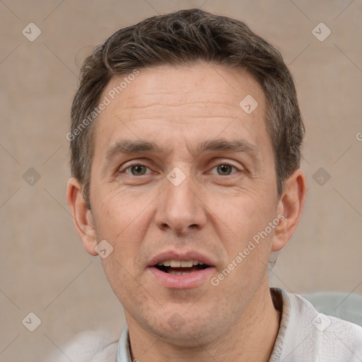 Joyful white adult male with short  brown hair and grey eyes