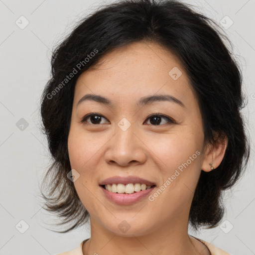 Joyful asian young-adult female with medium  brown hair and brown eyes