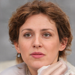 Joyful white adult female with medium  brown hair and green eyes