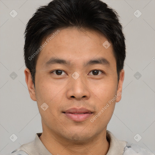 Joyful asian young-adult male with short  brown hair and brown eyes