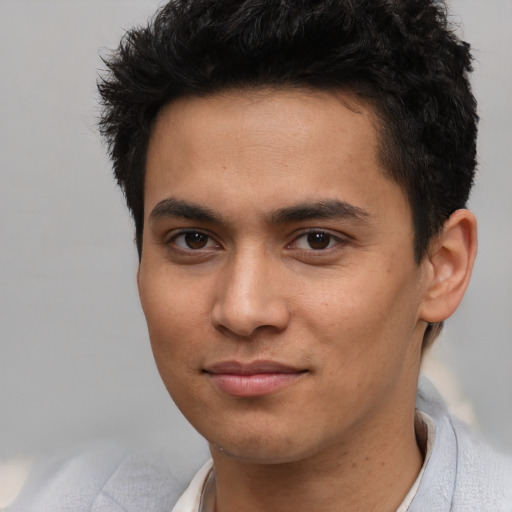 Joyful asian young-adult male with short  brown hair and brown eyes