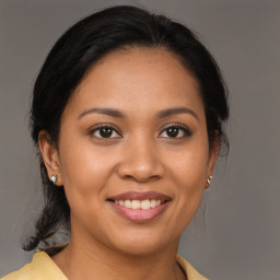 Joyful latino young-adult female with medium  brown hair and brown eyes