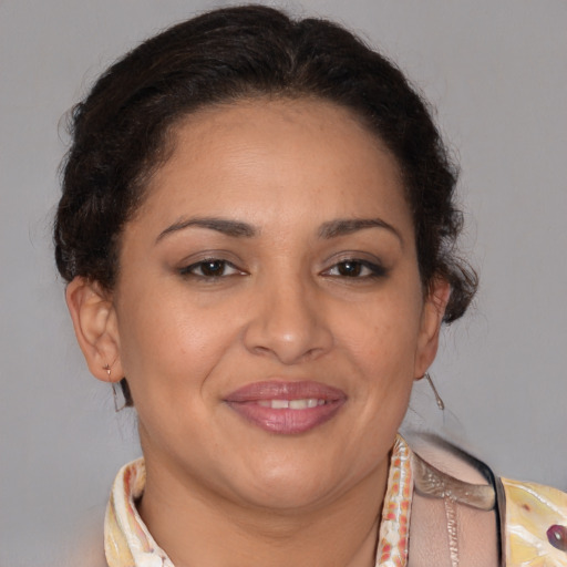 Joyful latino adult female with short  brown hair and brown eyes