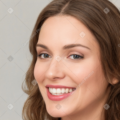 Joyful white young-adult female with long  brown hair and green eyes