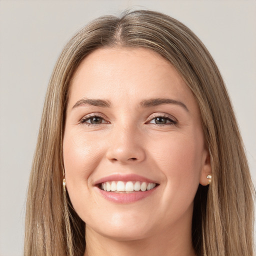 Joyful white young-adult female with long  brown hair and brown eyes