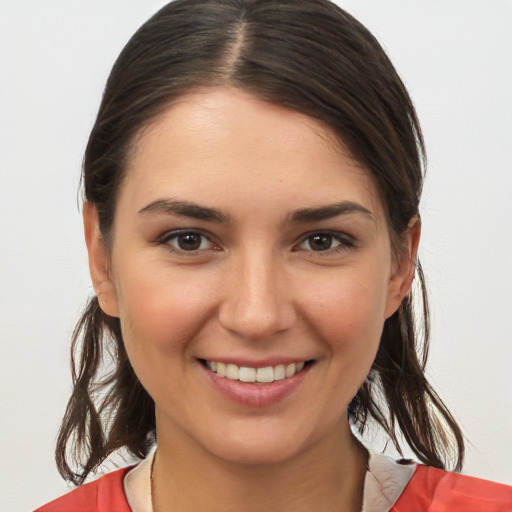 Joyful white young-adult female with medium  brown hair and brown eyes