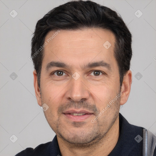 Joyful white adult male with short  black hair and brown eyes