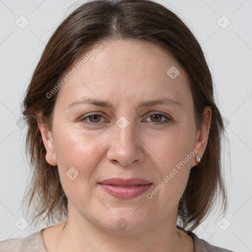 Joyful white adult female with medium  brown hair and grey eyes