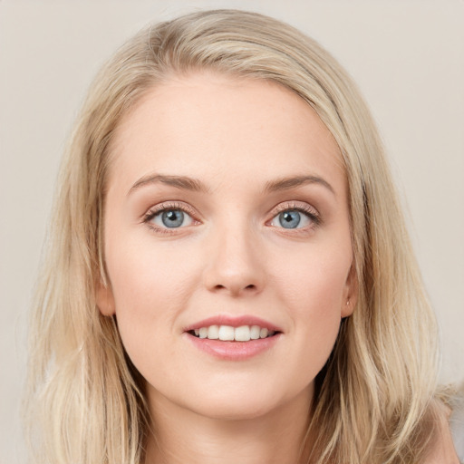 Joyful white young-adult female with long  brown hair and blue eyes