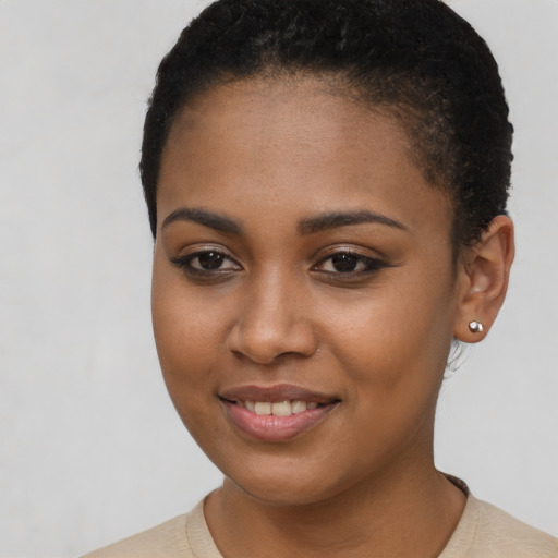 Joyful black young-adult female with short  brown hair and brown eyes