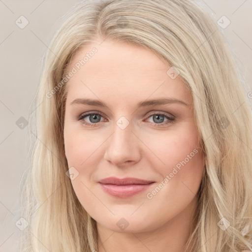 Joyful white young-adult female with long  brown hair and blue eyes