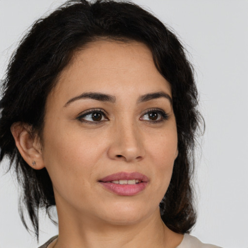 Joyful latino young-adult female with medium  brown hair and brown eyes