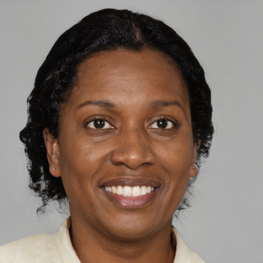 Joyful black adult female with medium  black hair and brown eyes
