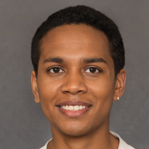 Joyful black young-adult male with short  black hair and brown eyes