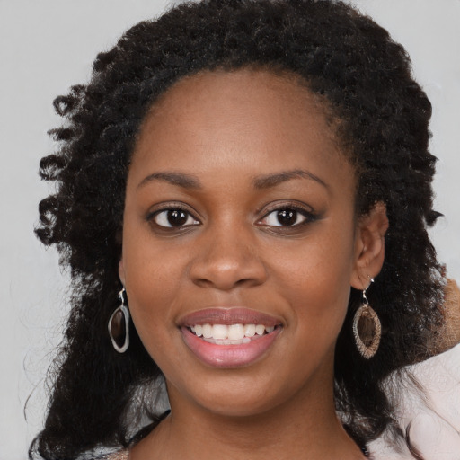 Joyful black young-adult female with medium  black hair and brown eyes