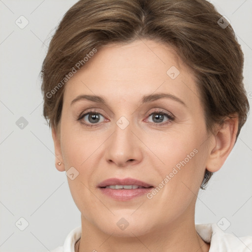 Joyful white adult female with short  brown hair and grey eyes