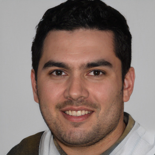 Joyful white young-adult male with short  black hair and brown eyes