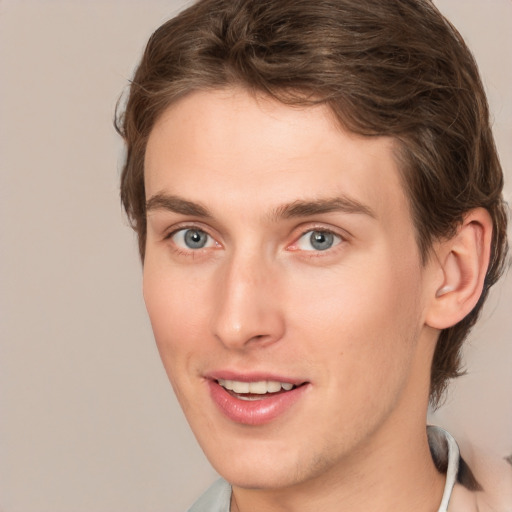 Joyful white young-adult male with medium  brown hair and brown eyes