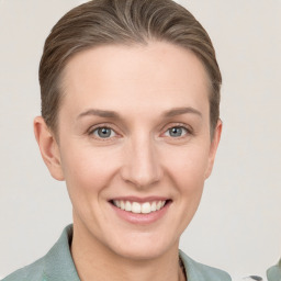 Joyful white young-adult female with medium  brown hair and grey eyes